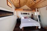 Queen Bed in Bunkhouse with Electric Fireplace